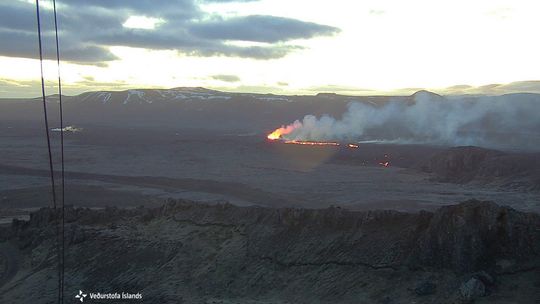 Image from the Icelandic Meteorological Office's webcam, taken at 5:10 AM, 16 April. The webcamera is located on top of Þorbjörn and looks east towards the eruption site. The crater is at the center of the image and lava flows from it. In front of the crater is Sundhnúkur, and on the right side of the image is Hagafell and lava flow fronts.