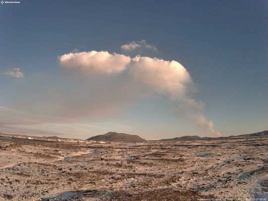 Photo since this morning (27. March) from IMO's webcam located at Hópsnes SE of Grindavík. In the center of the photo is Mt. Þorbjörn and the eruption site east of it where the gas plume rises and moves to the west because of easterly winds.